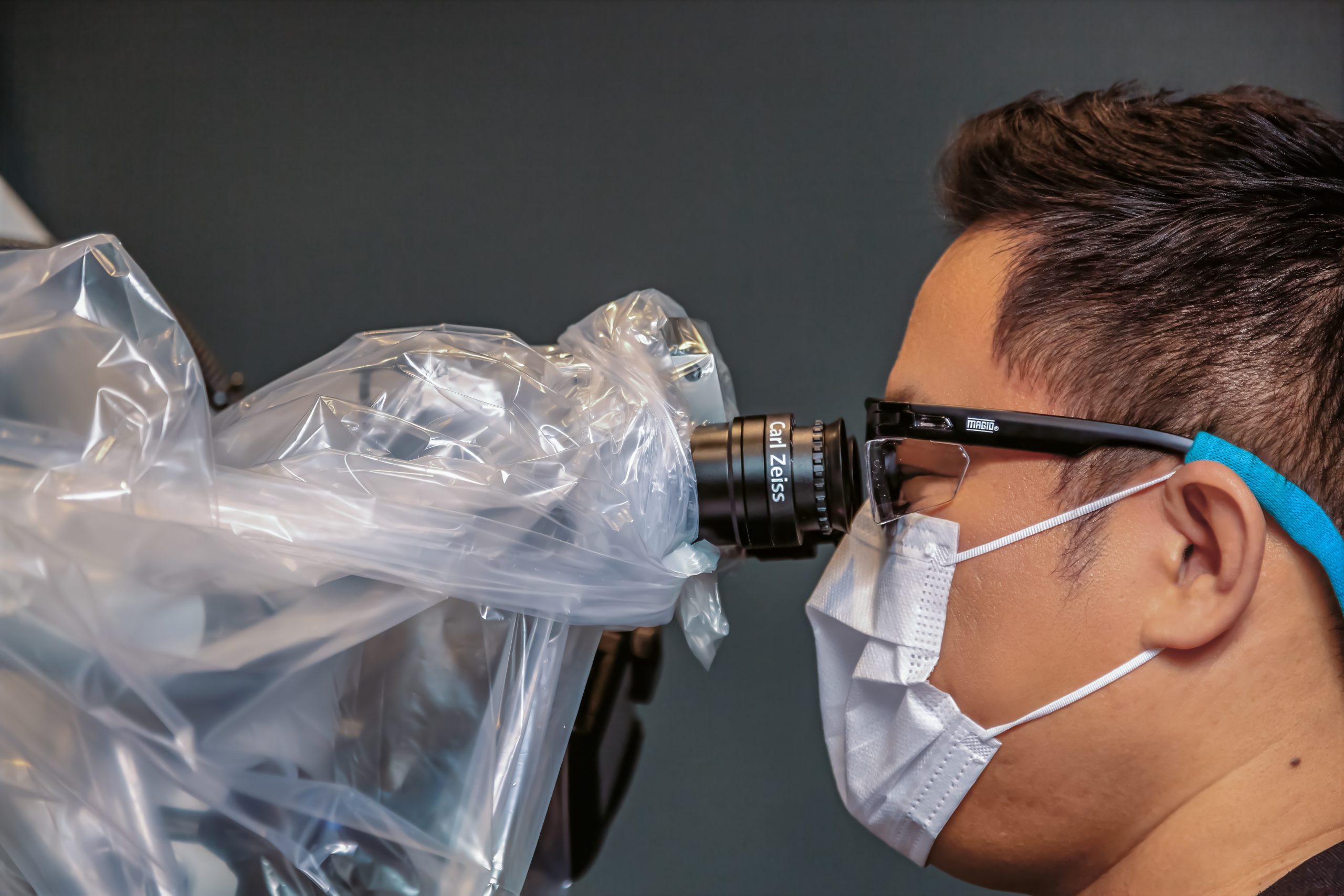 An image of a doctor using a microscope.