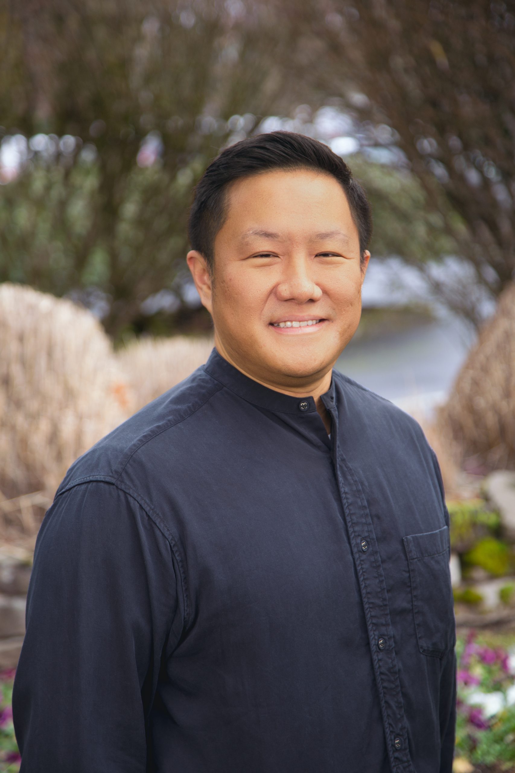 An image of Dr. Kedy Shen DMD wearing a navy blue shirt.